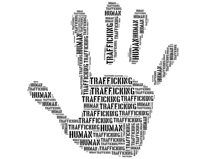 silhouette of a handprint filled with the repeated words "human trafficking"
