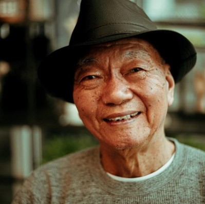 a senior citizen smiling at the camera